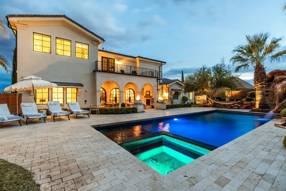 Illuminated house and pool at twilight at the Sunset property