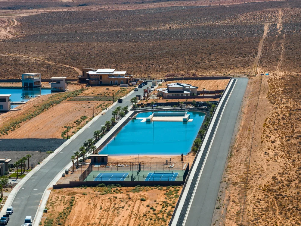 Aerial view of a pool, sports courts and neighboring roads at Southern Shores.