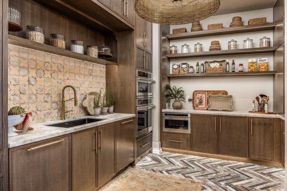 Butler pantry with built-in appliances, patterned tile and open shelving