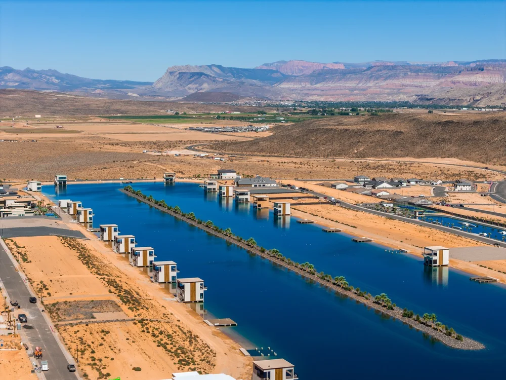 Elevated view along the waterfront development with distant desert terrain.
