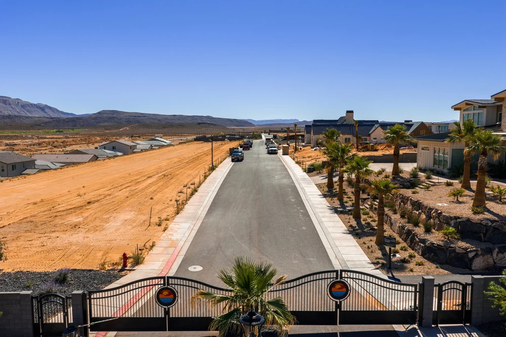 Elevated view of a gated roadway and neighboring properties at Southern Shores.