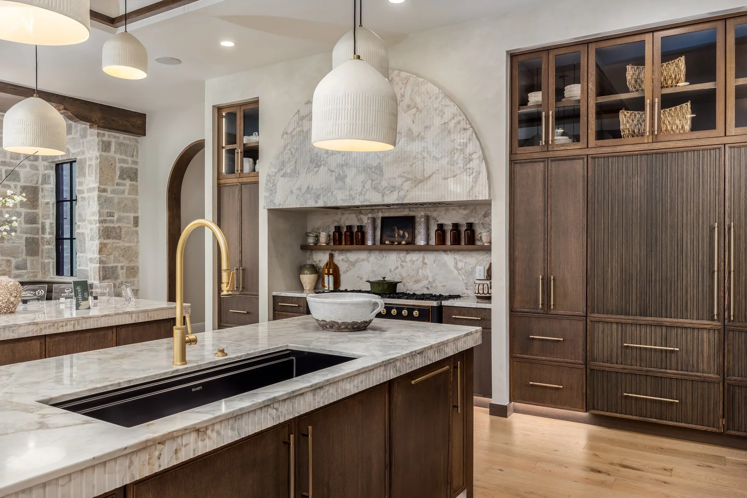 Wood cabinetry and a stone kitchen island — from Sam Reed’s photography portfolio
