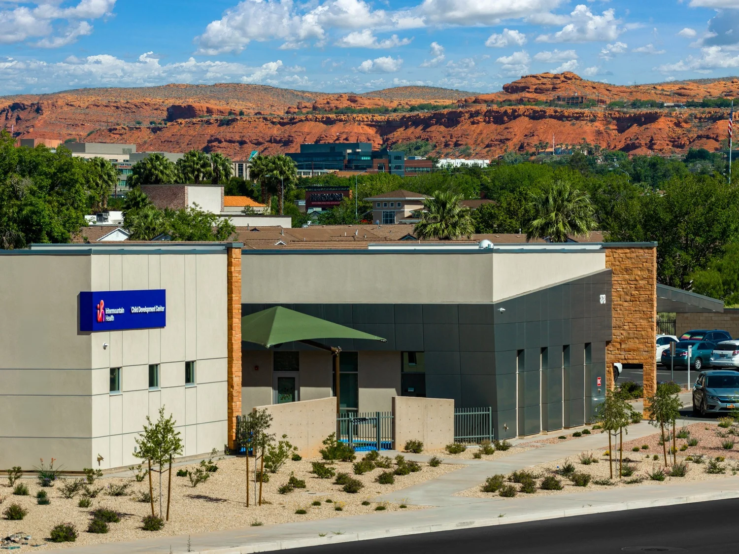 Intermountain Child Development Center set against distant red-rock cliffs.