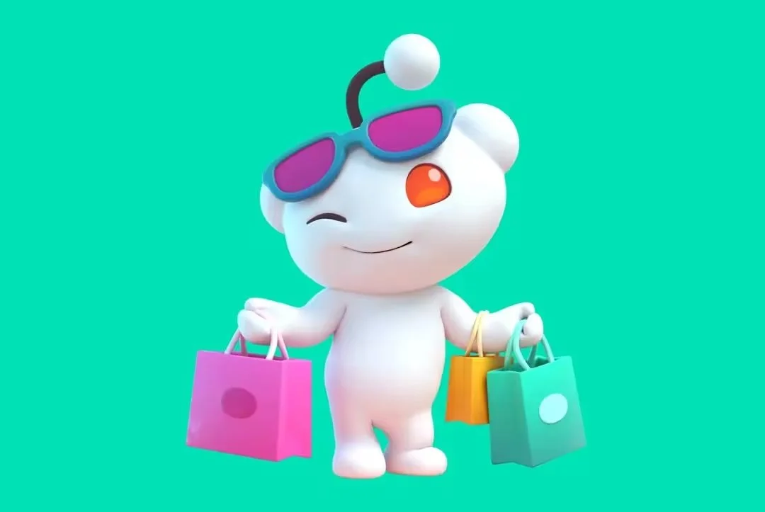 Reddit’s Snoo mascot wearing sunglasses and holding shopping bags on a turquoise background