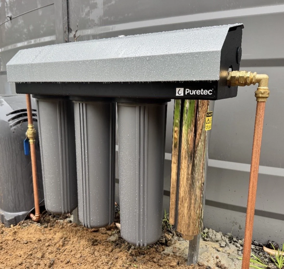 Puretec water filtration and UV installation with three filter housings and copper pipework