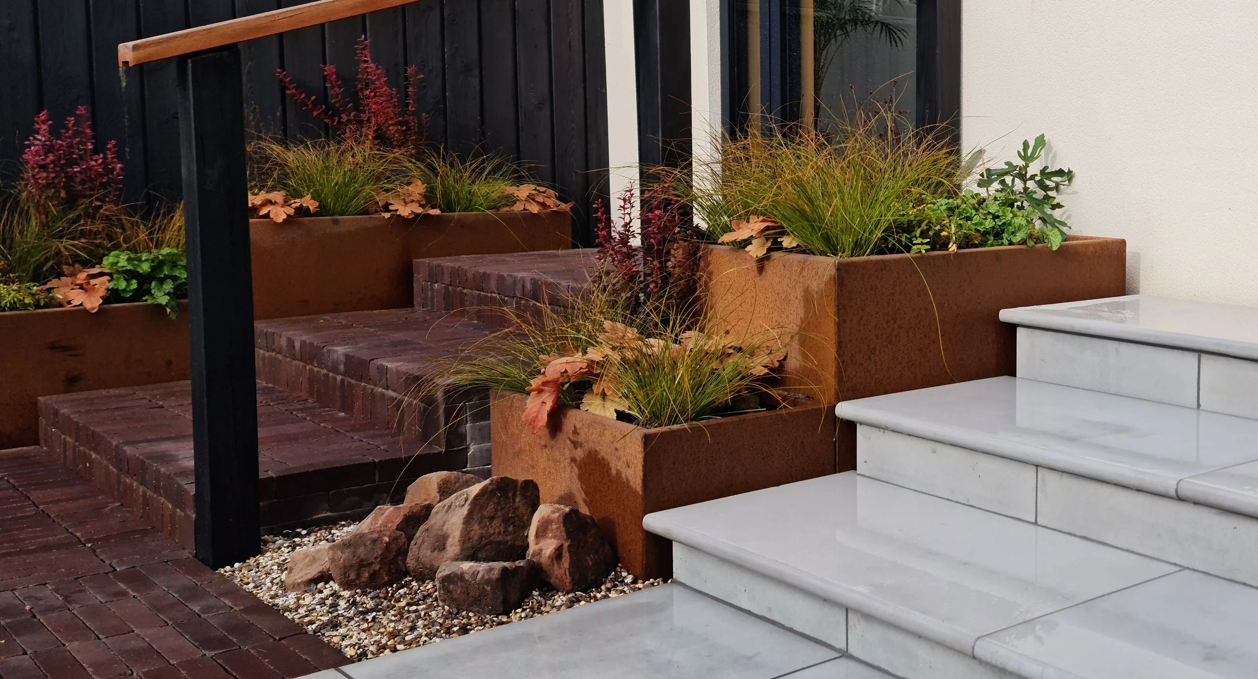 Contemporary garden with Nordic influence, combining clean lines, soft planting and natural textures