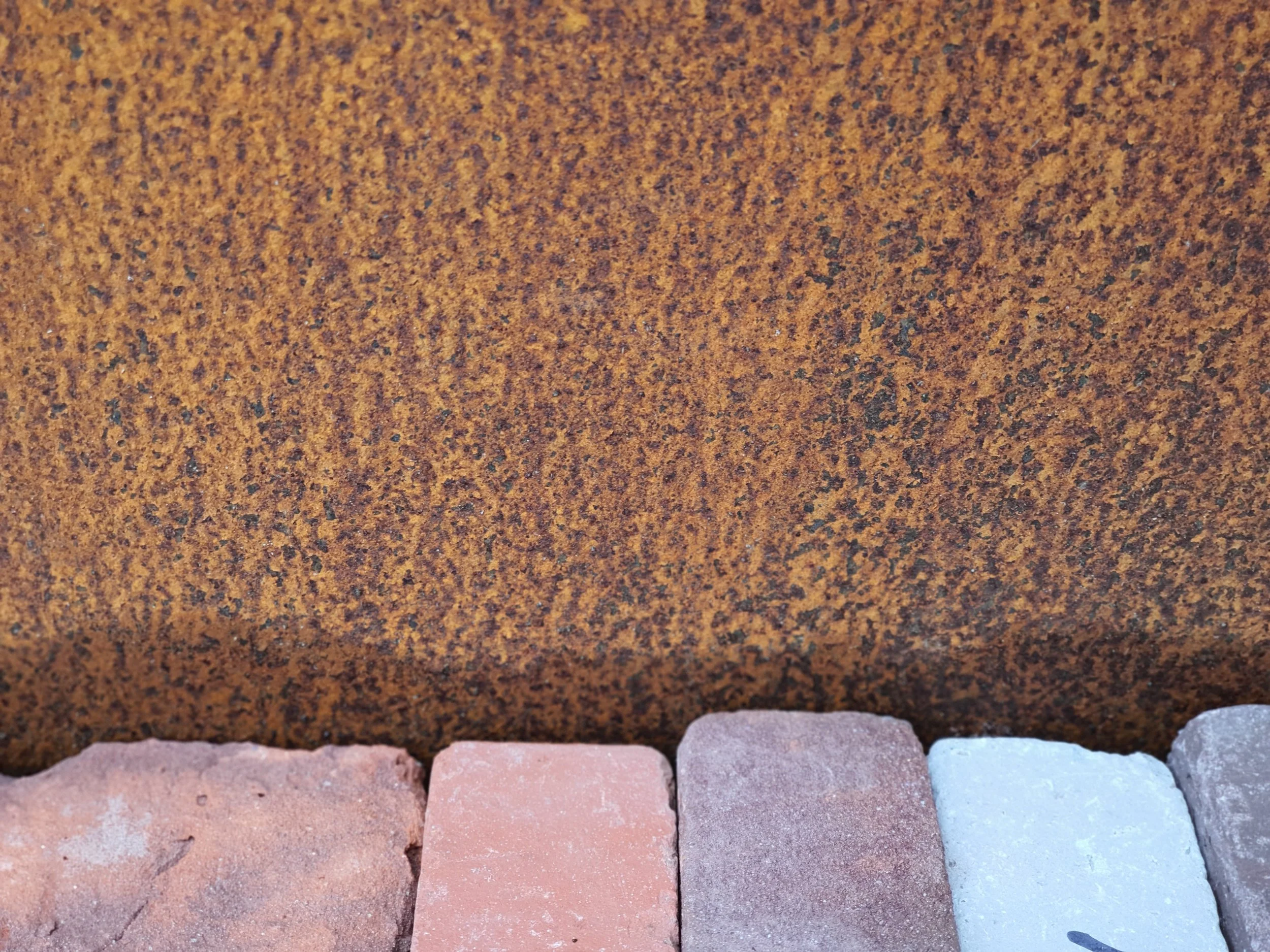 Selection of clay paving pavers and corten samples for garden design materials