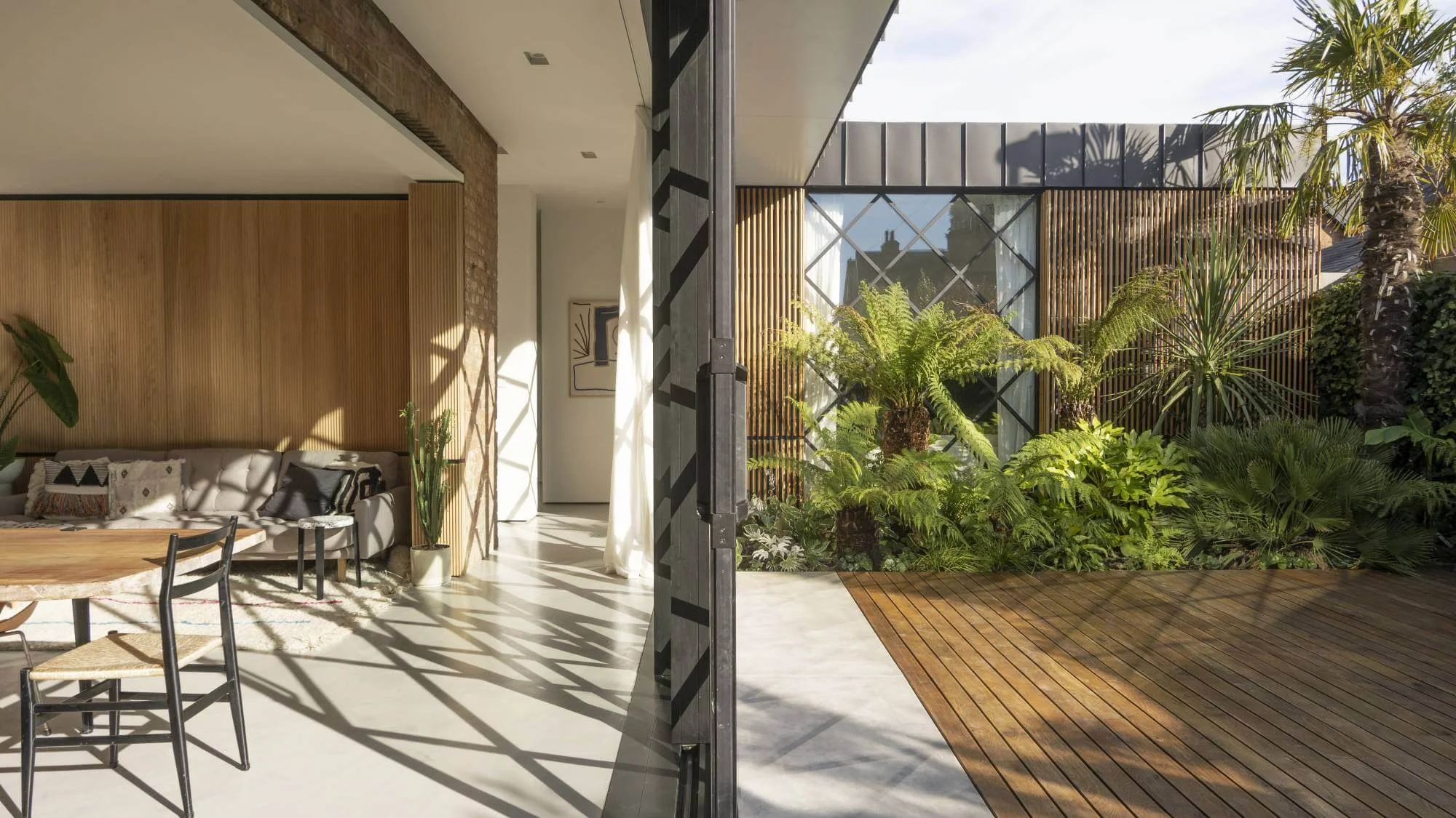 Architectural garden with pale paving and structured planting