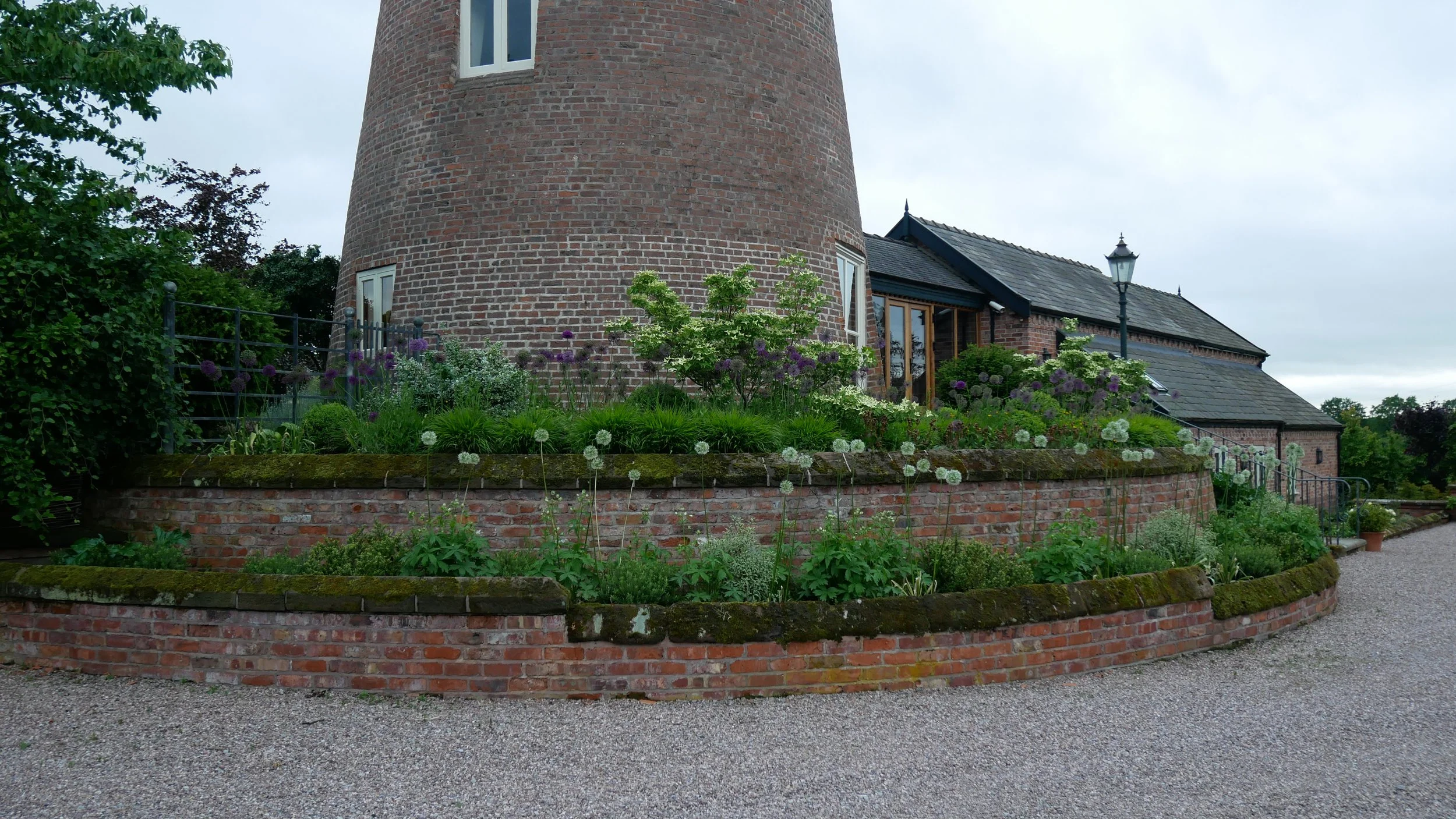 Historic windmill set within the wider garden and surrounding rural landscape