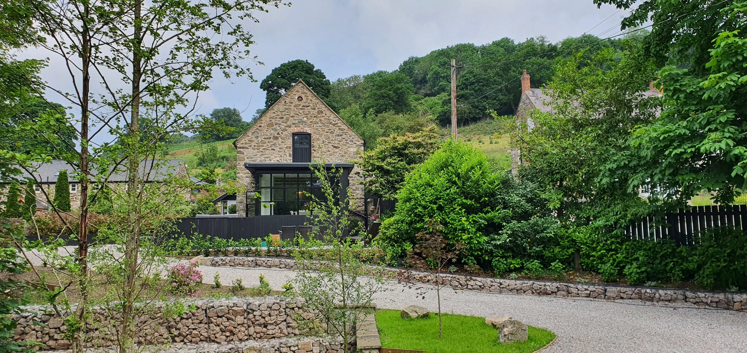 New driveway with gabions at coach house garden in St Asaph