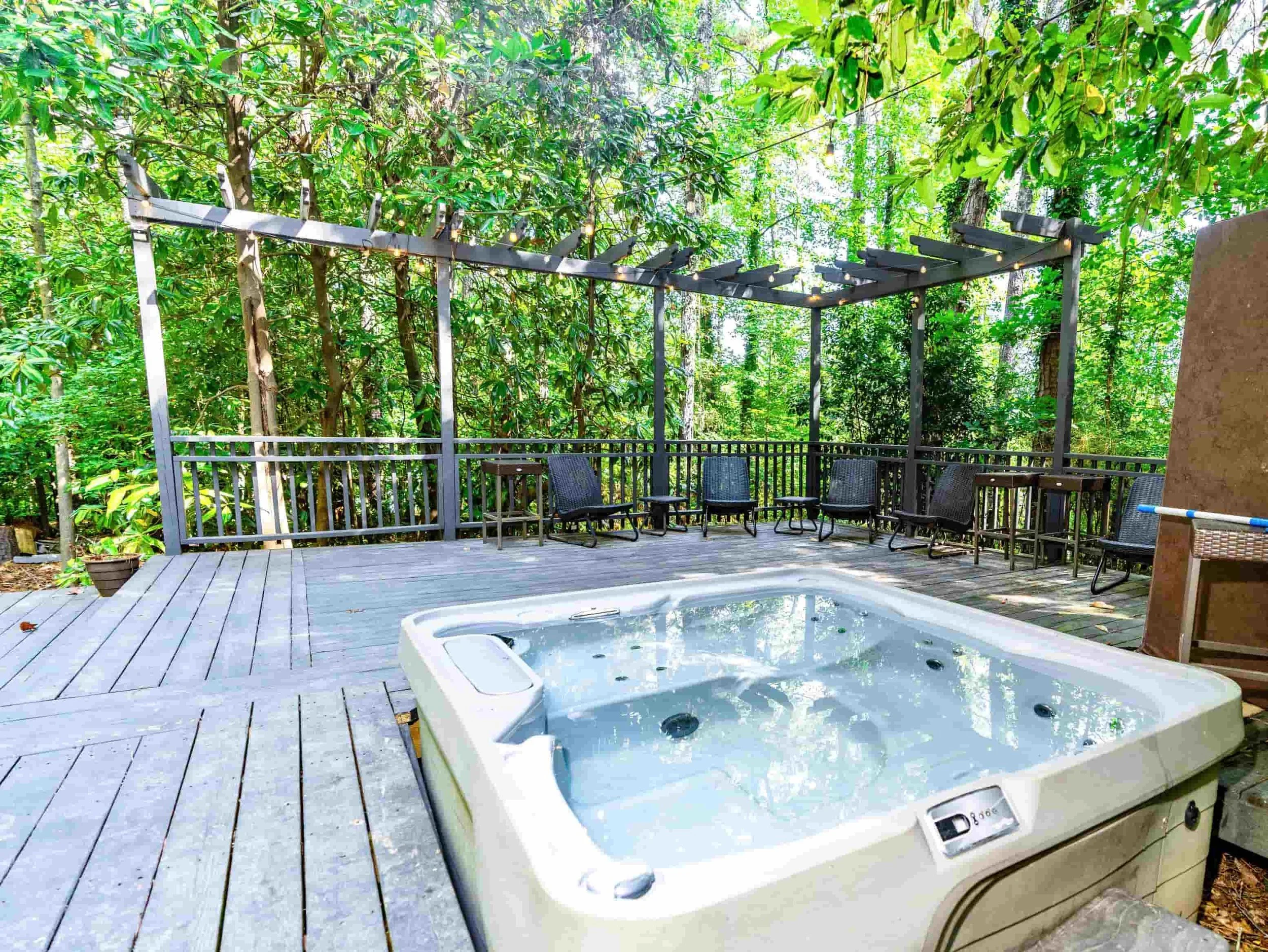 Shared hot tub under the trees at Maxam East Point Atlanta