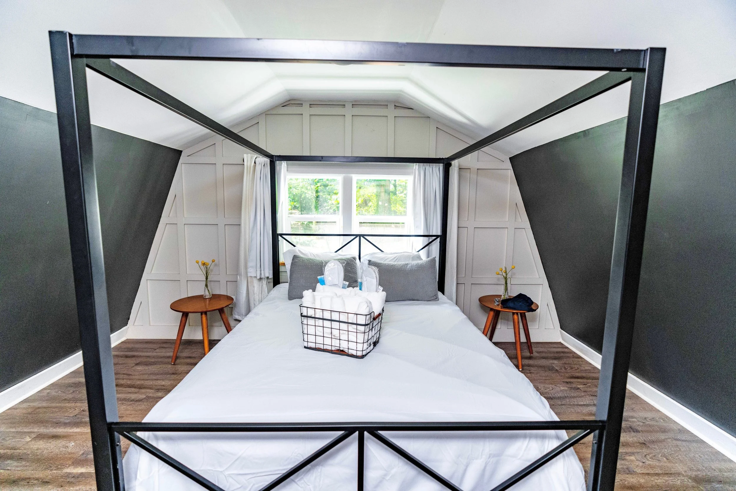 Queen bed with soft linens and nature views in the loft bedroom