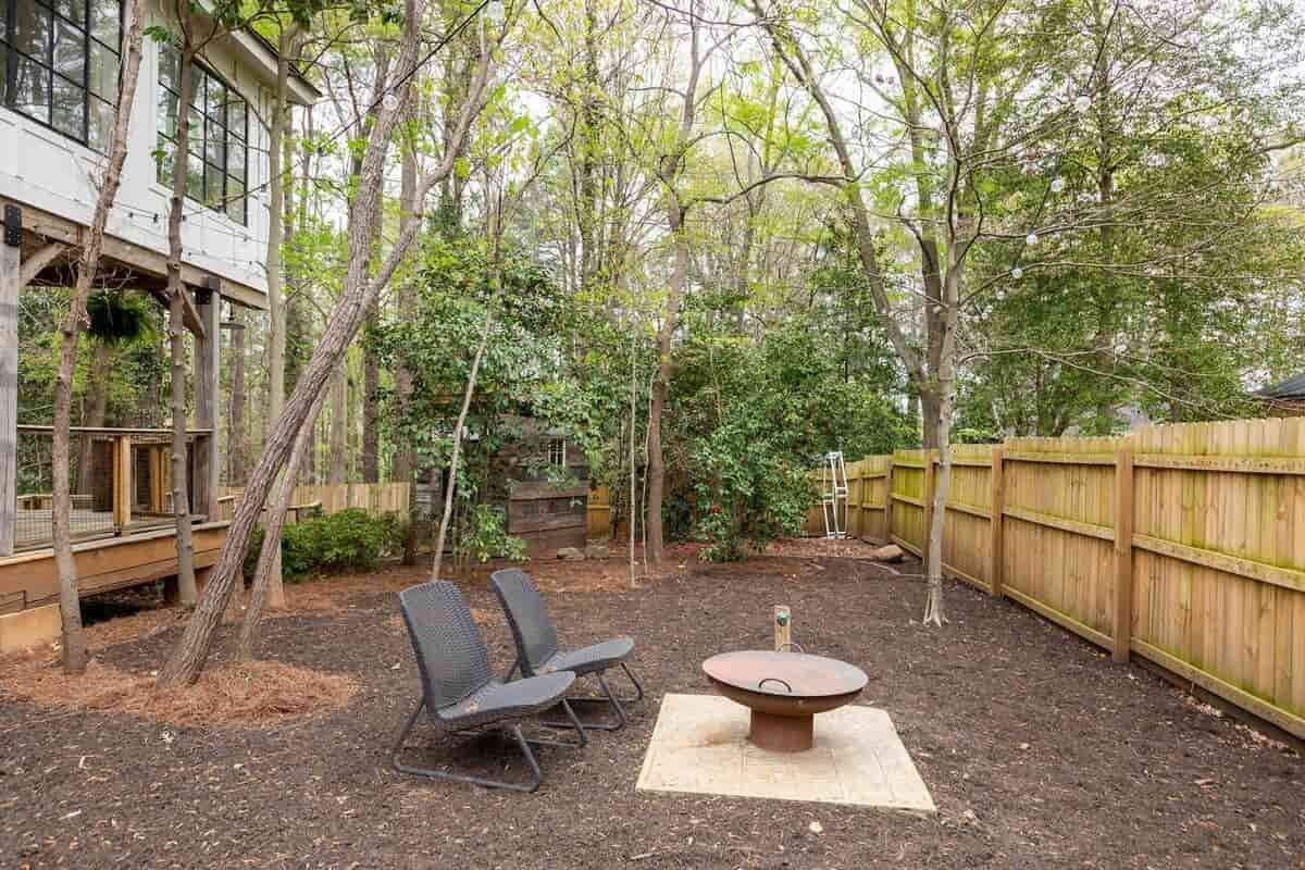 Second outdoor seating area among the trees