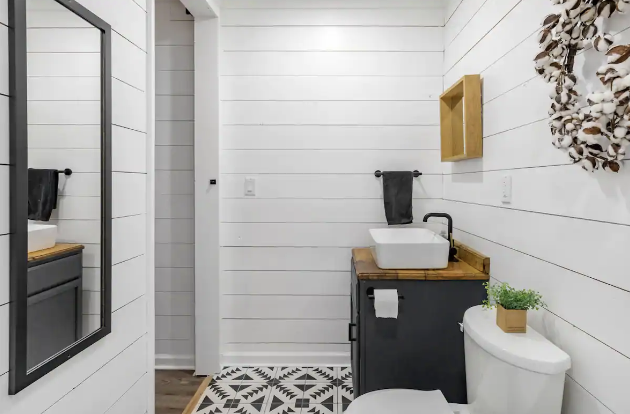 Bathroom vanity with farmhouse details and plush towels