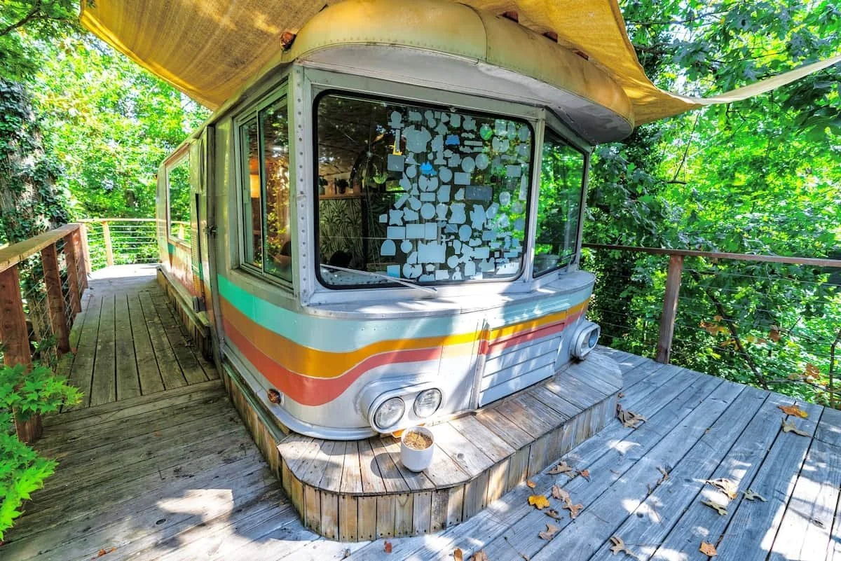 Vintage 1950s Airstream Spartan RV elevated into the treehouse deck
