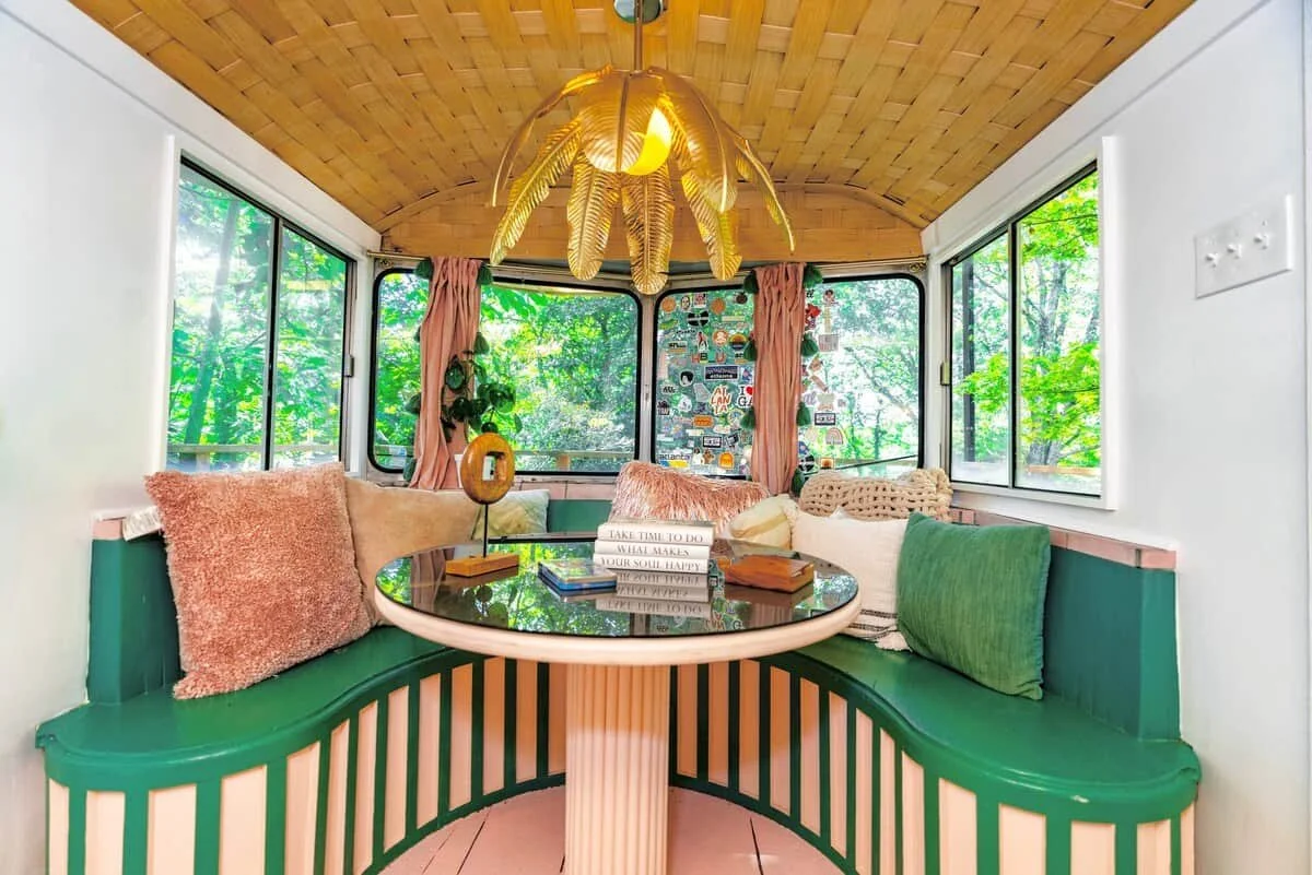Airstream treehouse deck with outdoor seating and garden views at dusk, East Point Atlanta