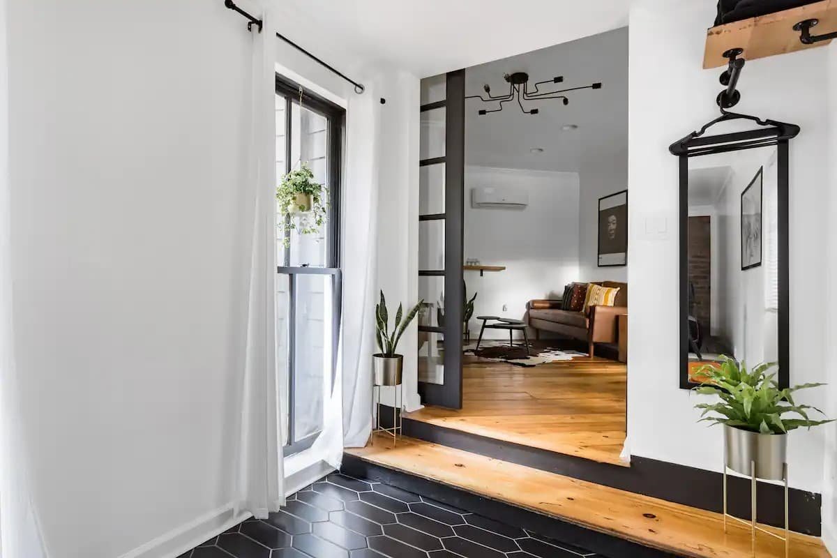 Historic bungalow living area with vintage theater chairs and heart pine floors