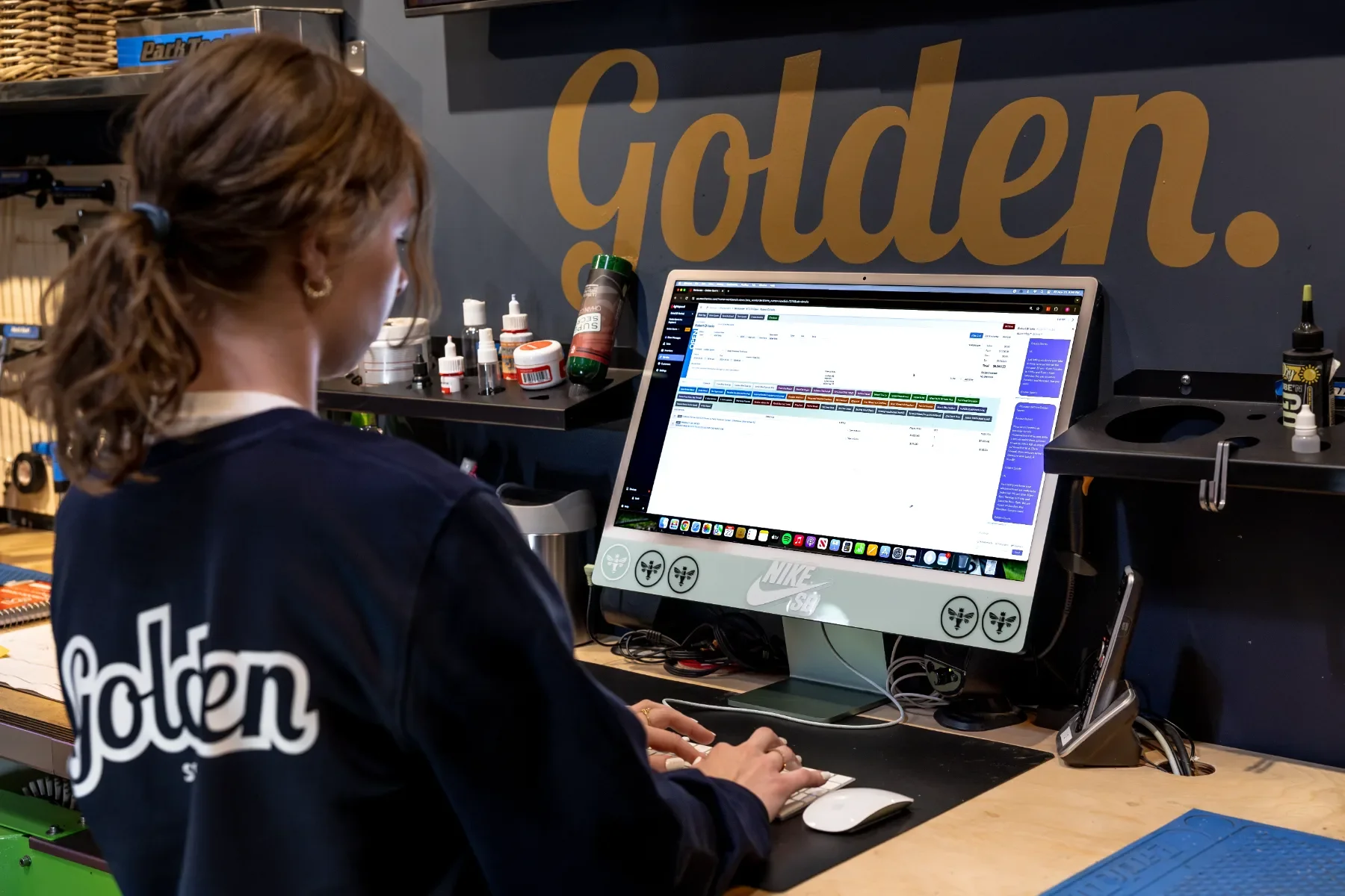 Golden Sports team member working in Lightspeed with Ikeono at the service counter