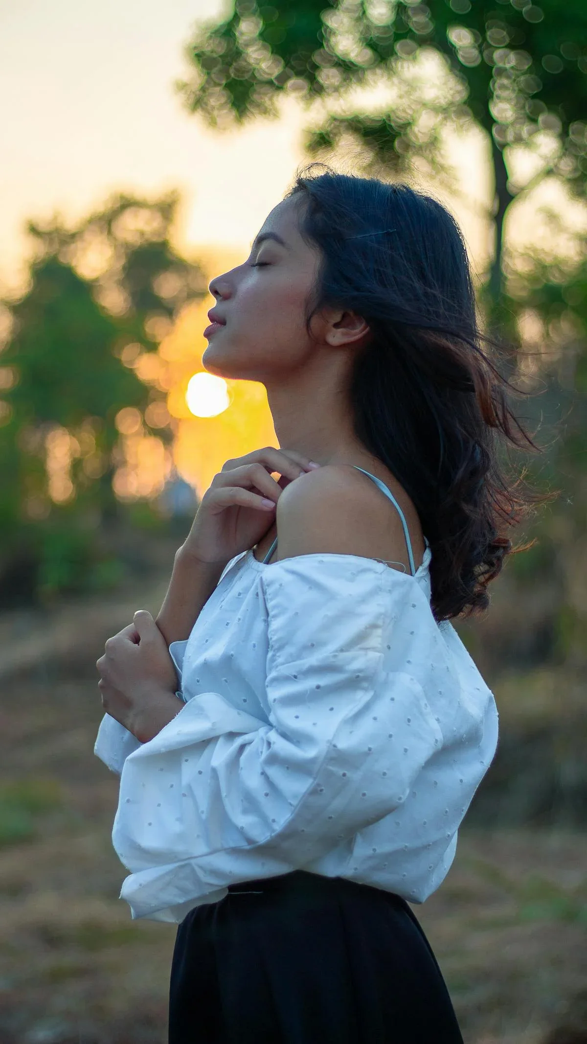 Woman at peace in golden hour light — hormonal balance, mood, and energy through BHRT