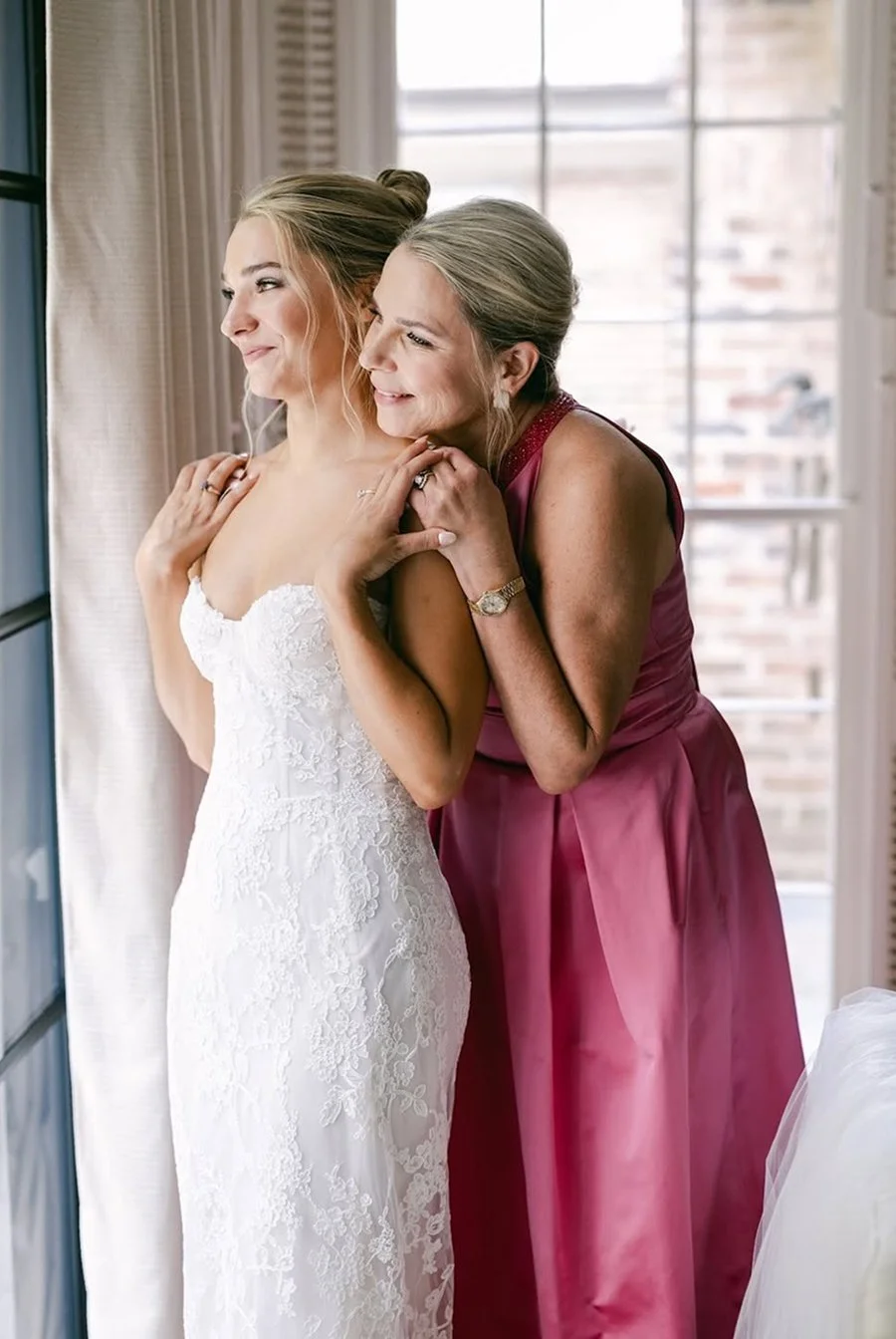 Mother of the bride and bride in custom gowns