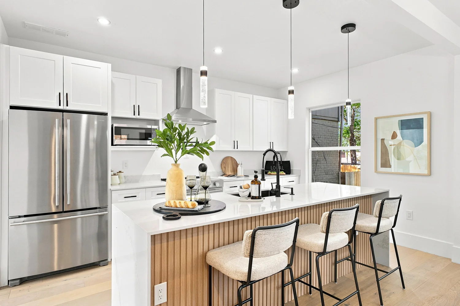 Remodeled kitchen with waterfall island and stainless appliances