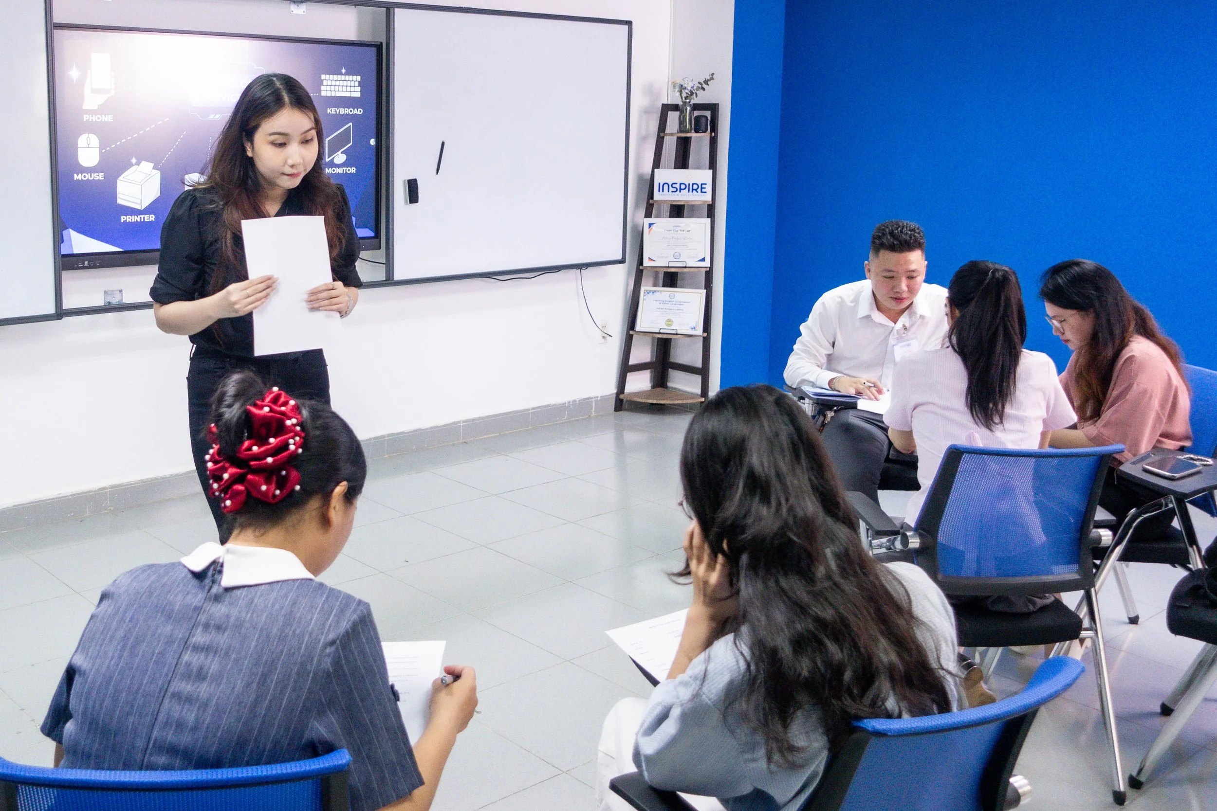 TESOL teacher demonstrating a classroom activity