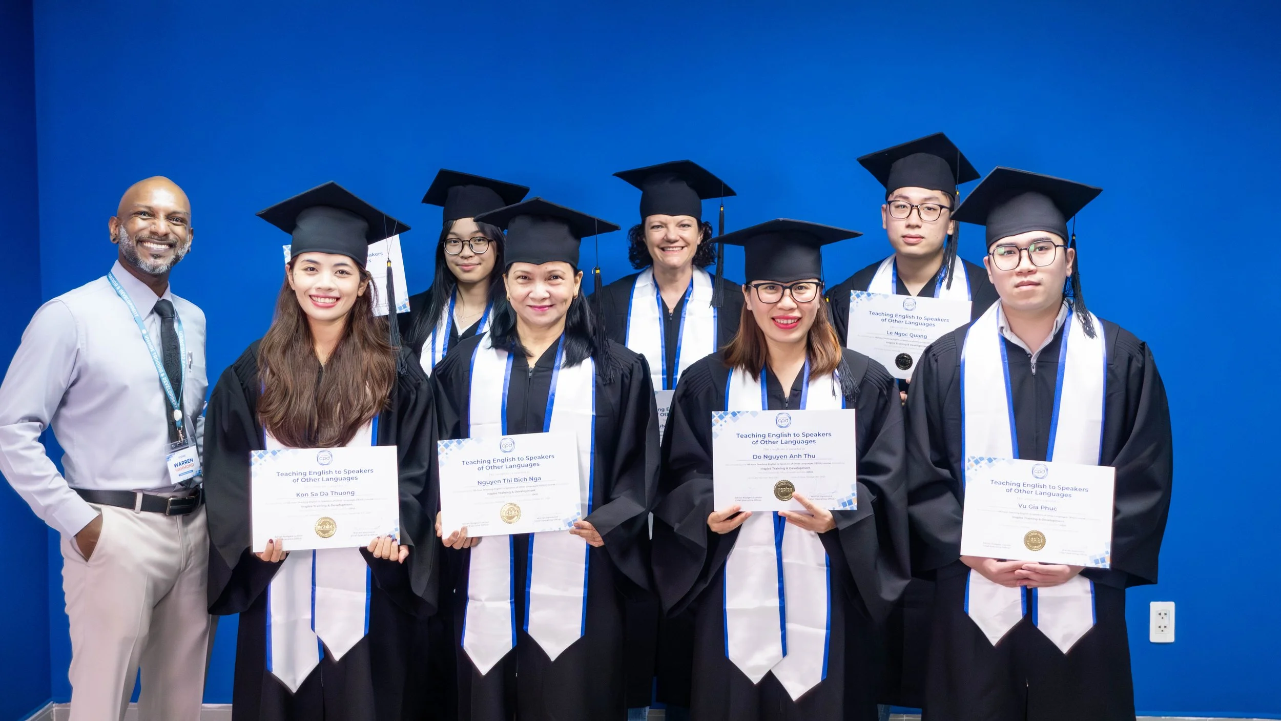 TESOL graduates holding certificates after completing their training in Vietnam