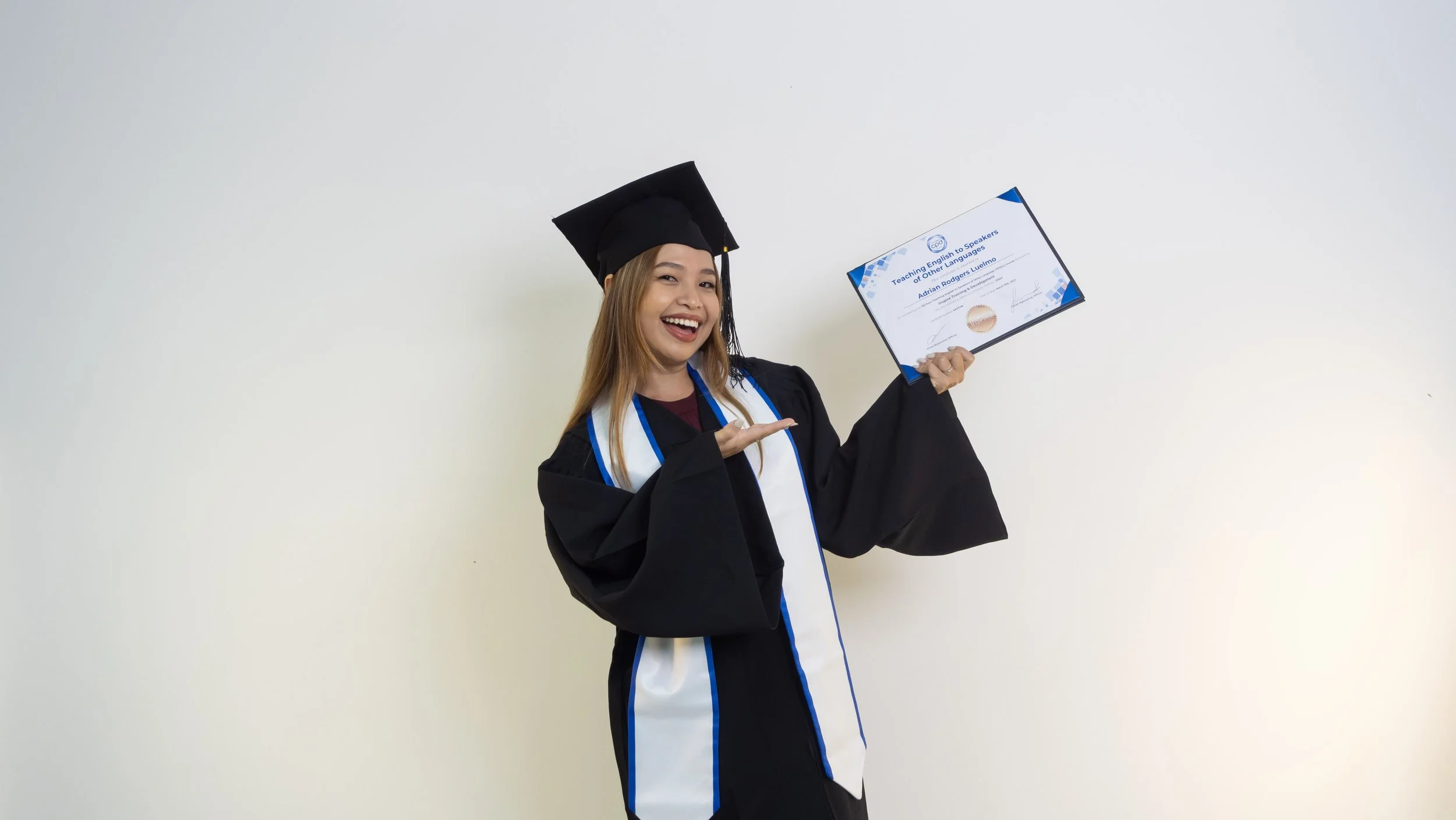 TESOL graduate holding an Inspire certificate