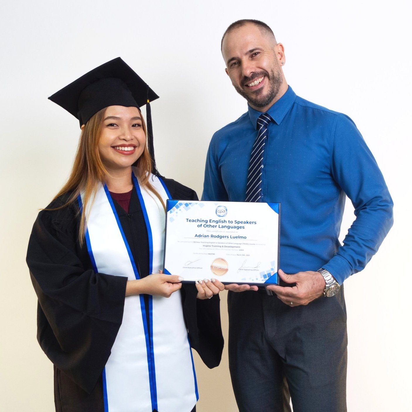Teacher and trainee holding an Inspire certificate