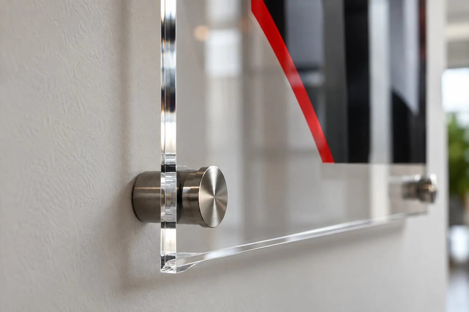 Close detail of a polished acrylic sign edge and metal standoff hardware