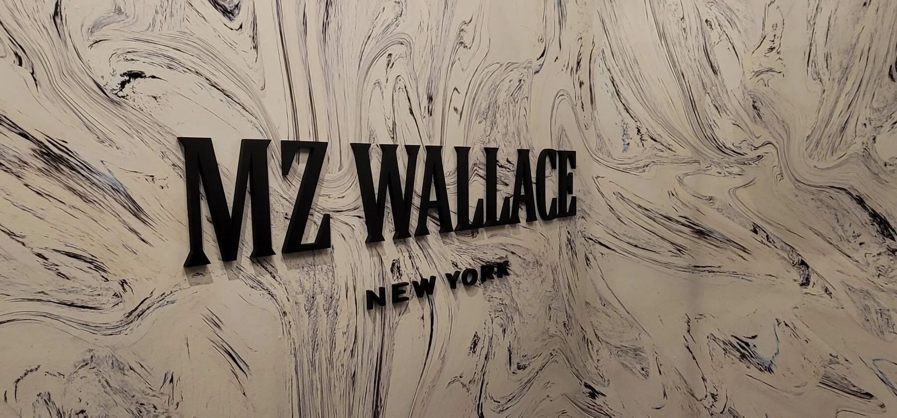 MZ Wallace New York dimensional black logo letters on a decorative wall