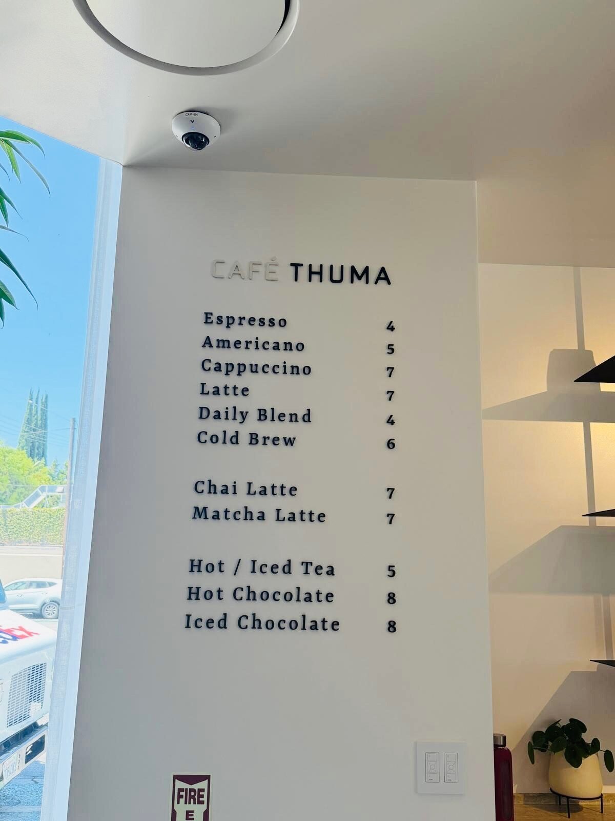 Cafe Thuma dimensional menu lettering installed on a light interior wall