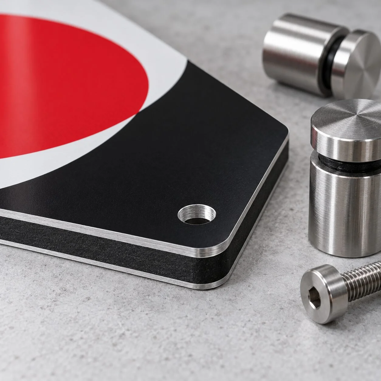 Close detail of Dibond aluminum composite panel edges and stainless standoff hardware