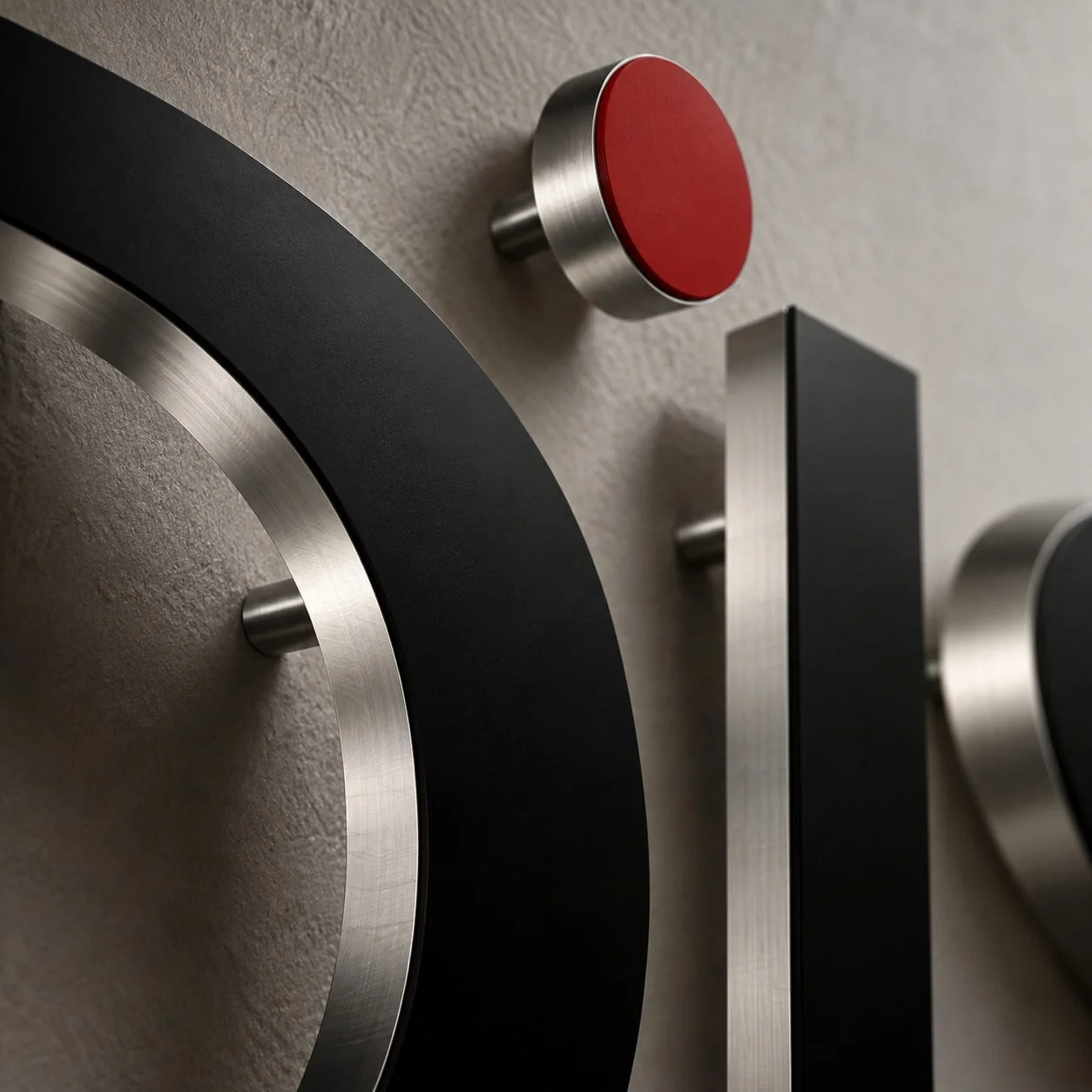 Close detail of brushed metal and matte acrylic lobby signage on standoffs