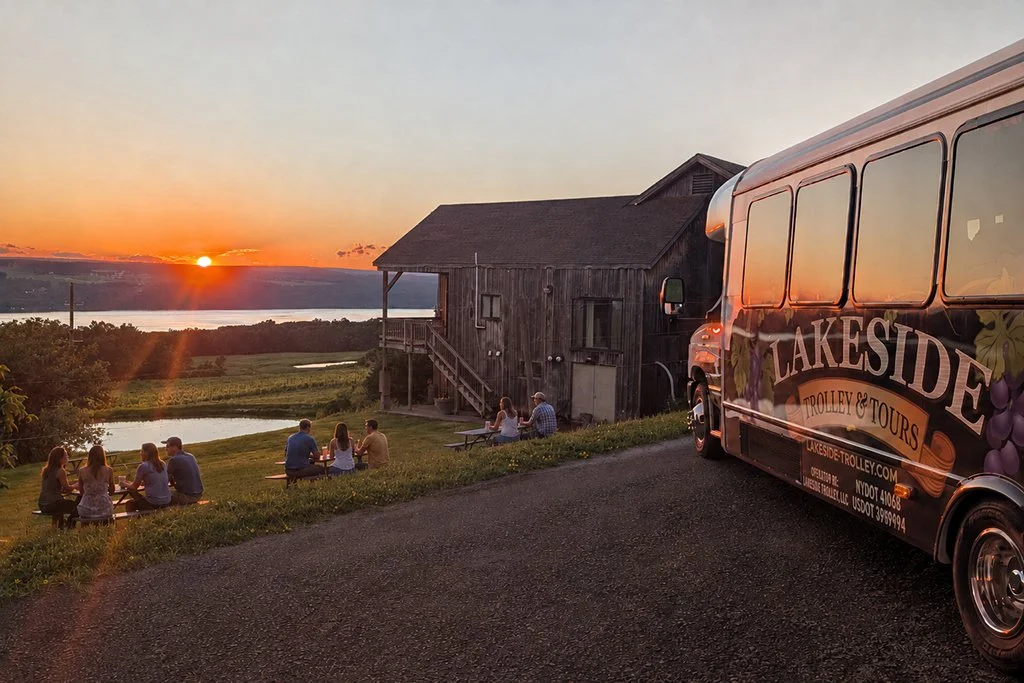 Guests enjoying a Finger Lakes craft beverage tour during the evening