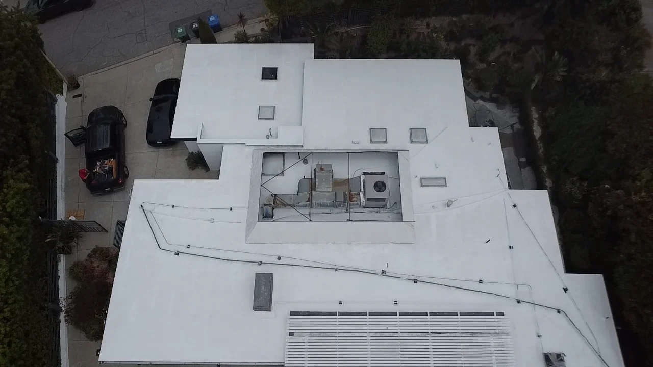 Sherman Oaks flat roof after Stonebridge sheathing repairs, slope corrections and white silicone coating