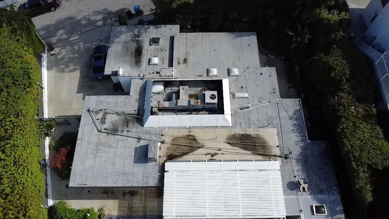 Existing Sherman Oaks flat roof with weathered surfaces and ponding-water staining
