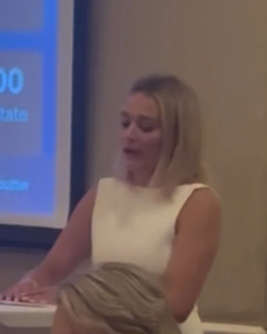 Evane Stoner speaking at a podium during a fundraising event