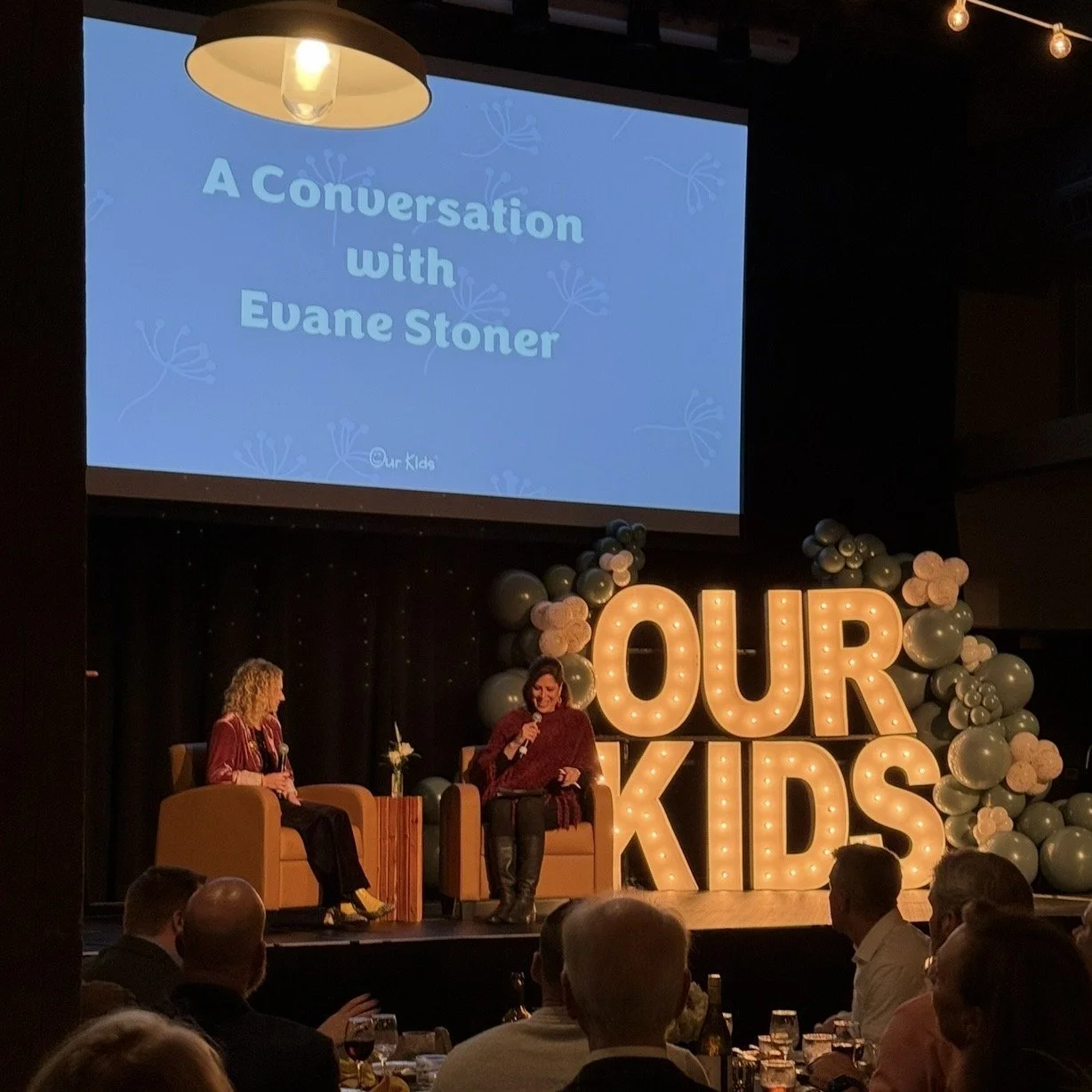Evane Stoner in conversation on stage at an Our Kids event