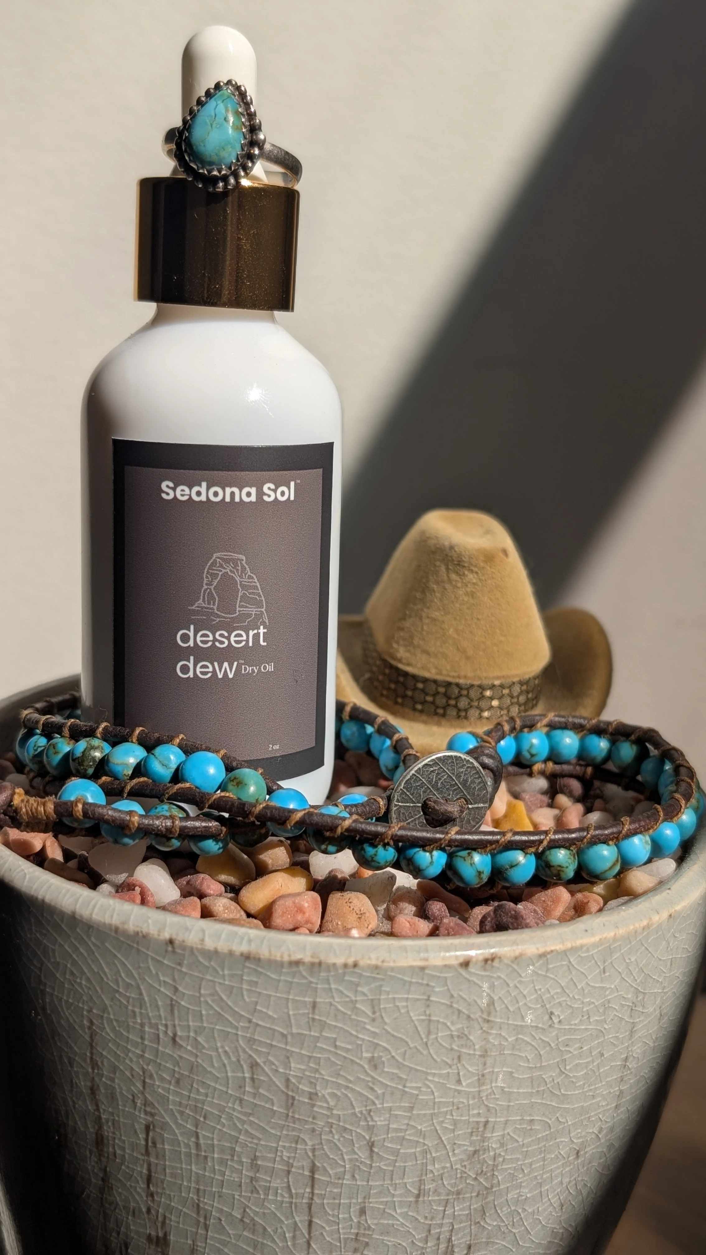 Sedona Sol Desert Dew spray tan safe hydrating dry body oil bottle with turquoise jewelry at Be Bold the Salon in Woods Cross Utah