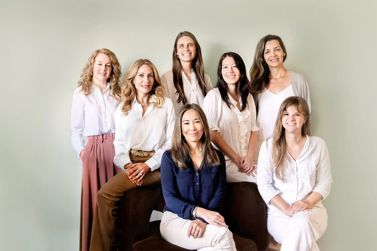 The seven clinicians of Lisa Chen & Associates Therapy, with founder Lisa Chen, LMFT, seated center