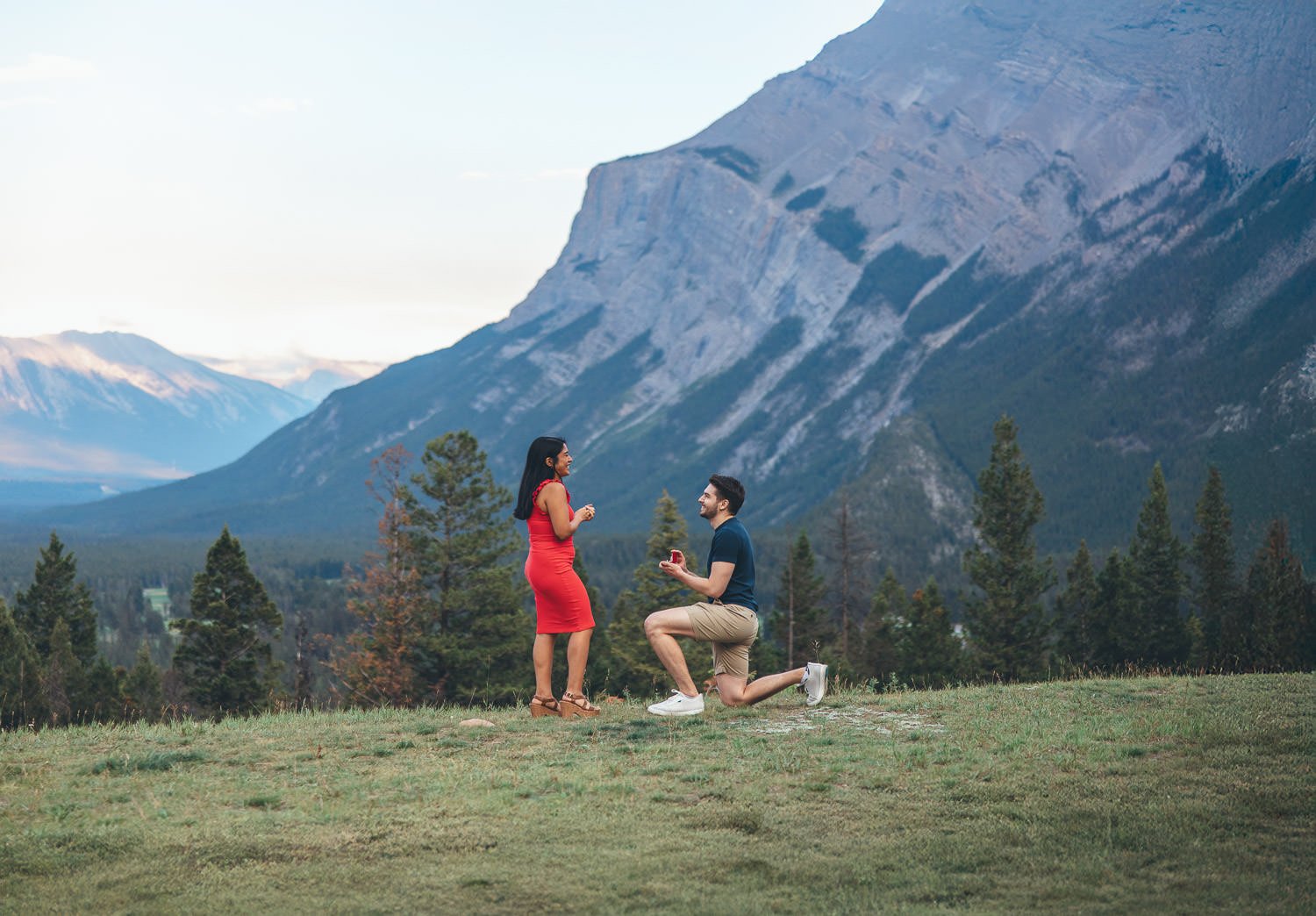 Tunnel Mountain Reservoir in summer, featuring vibrant greenery and clear mountain views.