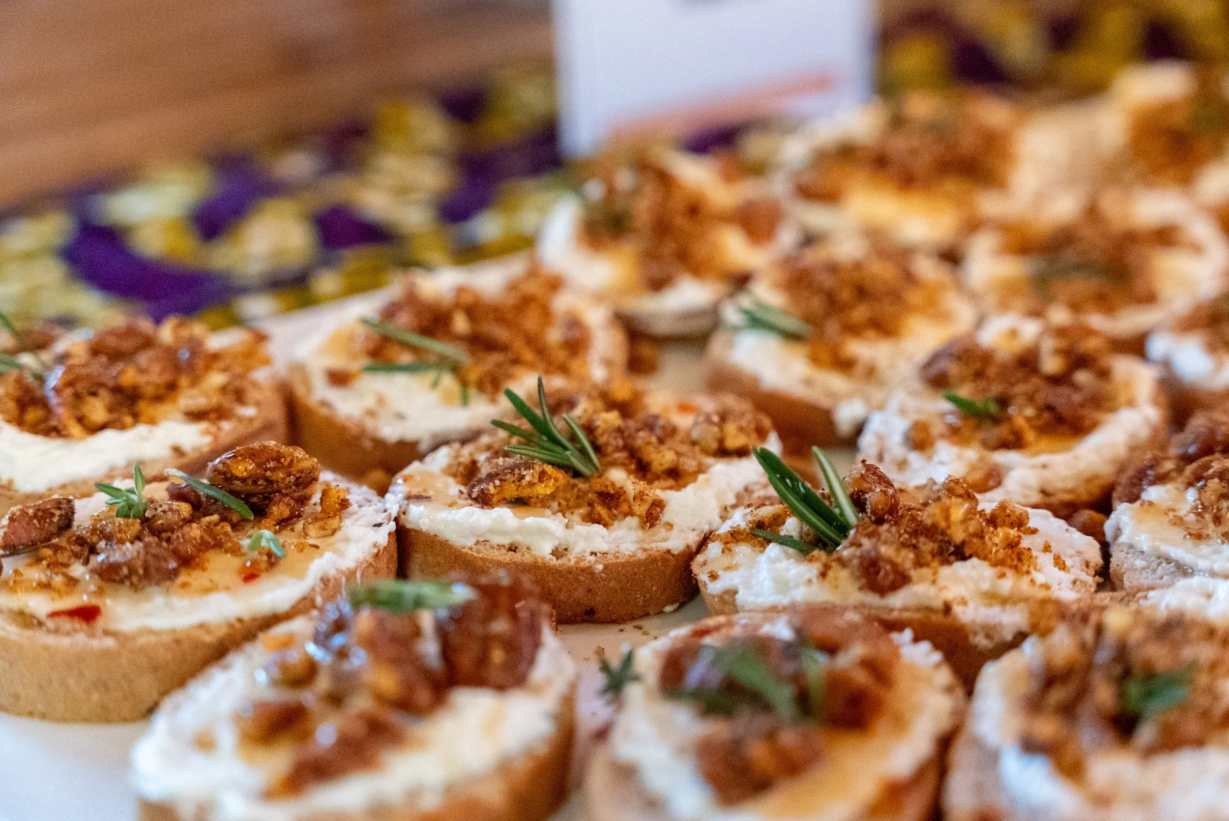 Whipped feta crostini with hot honey, candied nuts and rosemary