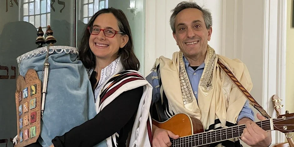 Rabbi Shoshana Leis holding a Torah scroll and Rabbi Ben Newman holding a guitar, both in tallitot.