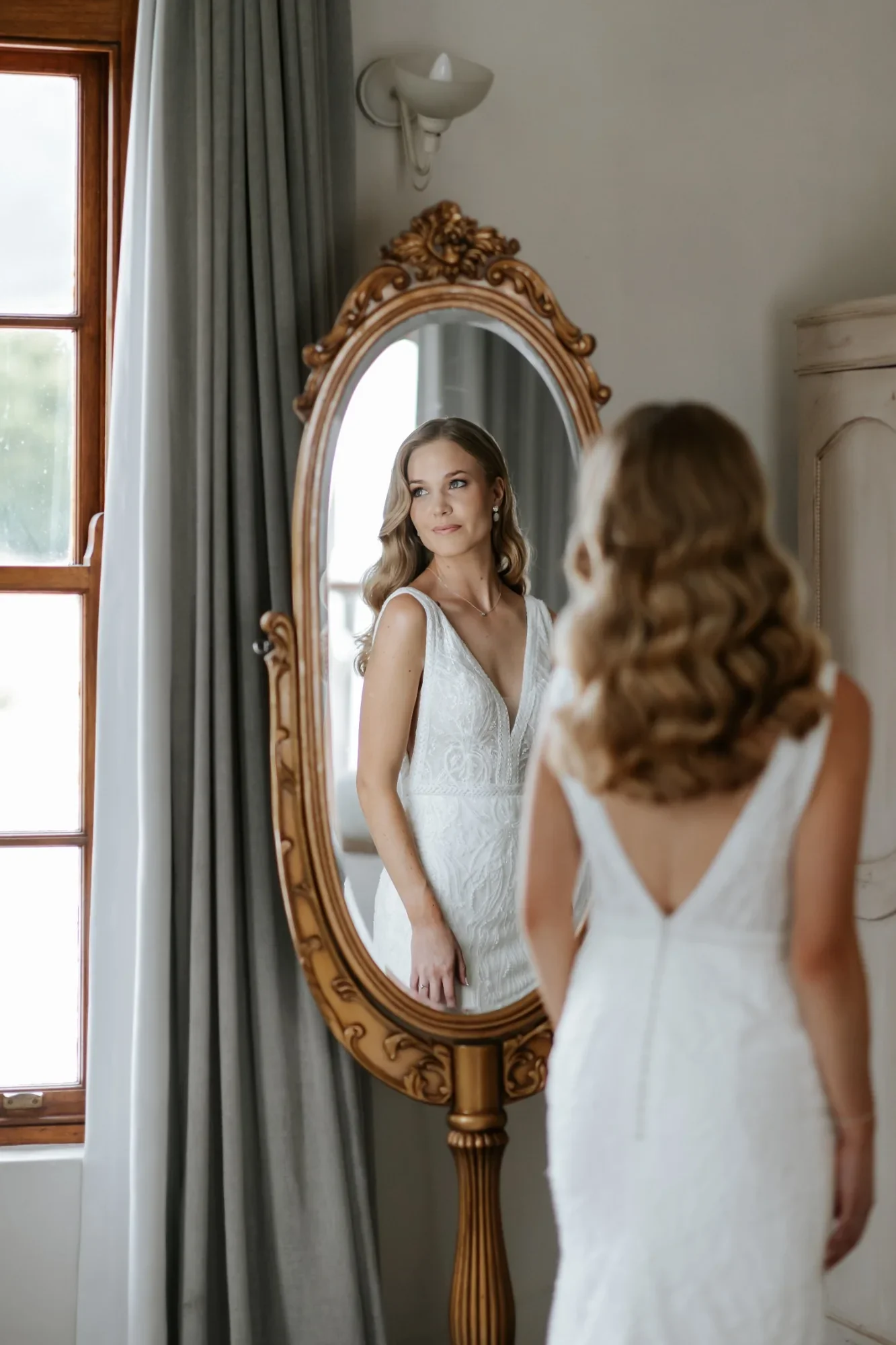 Bride reflected in antique mirror