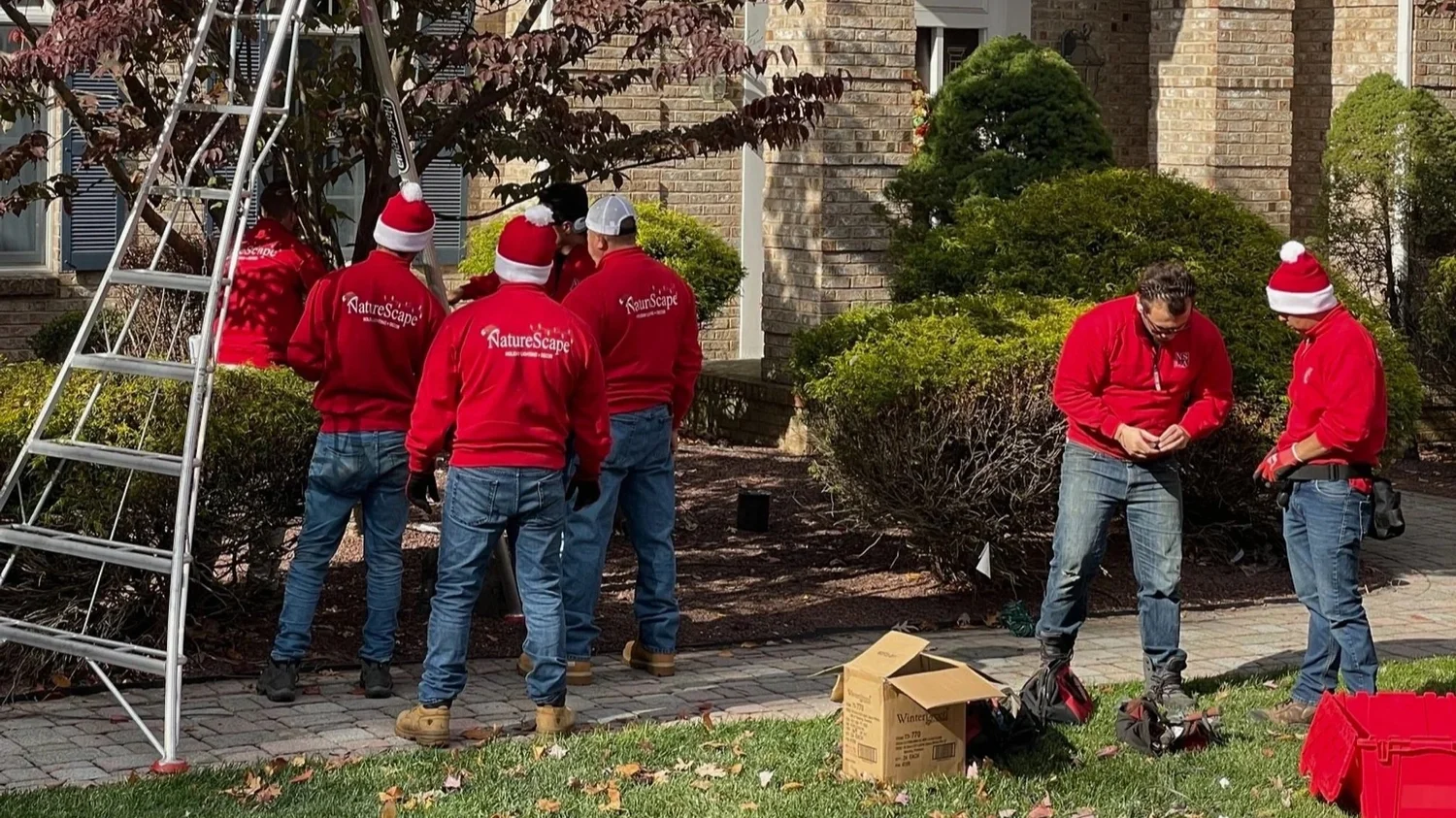 NatureScape Lighting + Audio team installing holiday lighting and décor at a New Jersey home