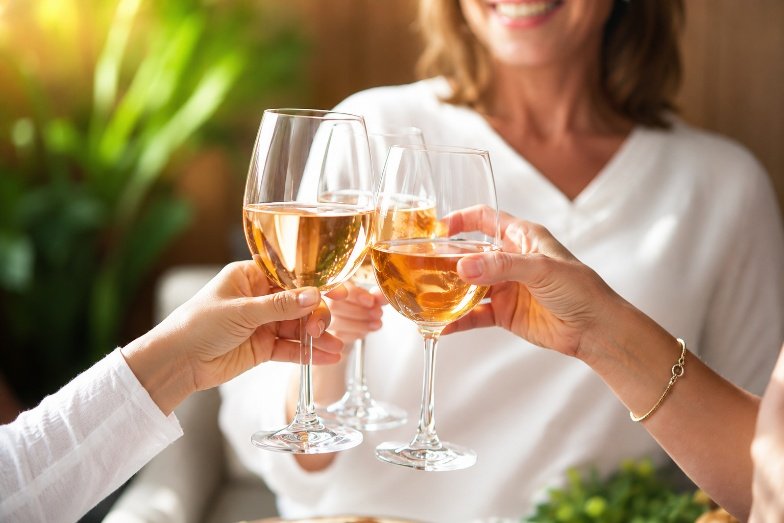 Adults raising glasses together at a social gathering