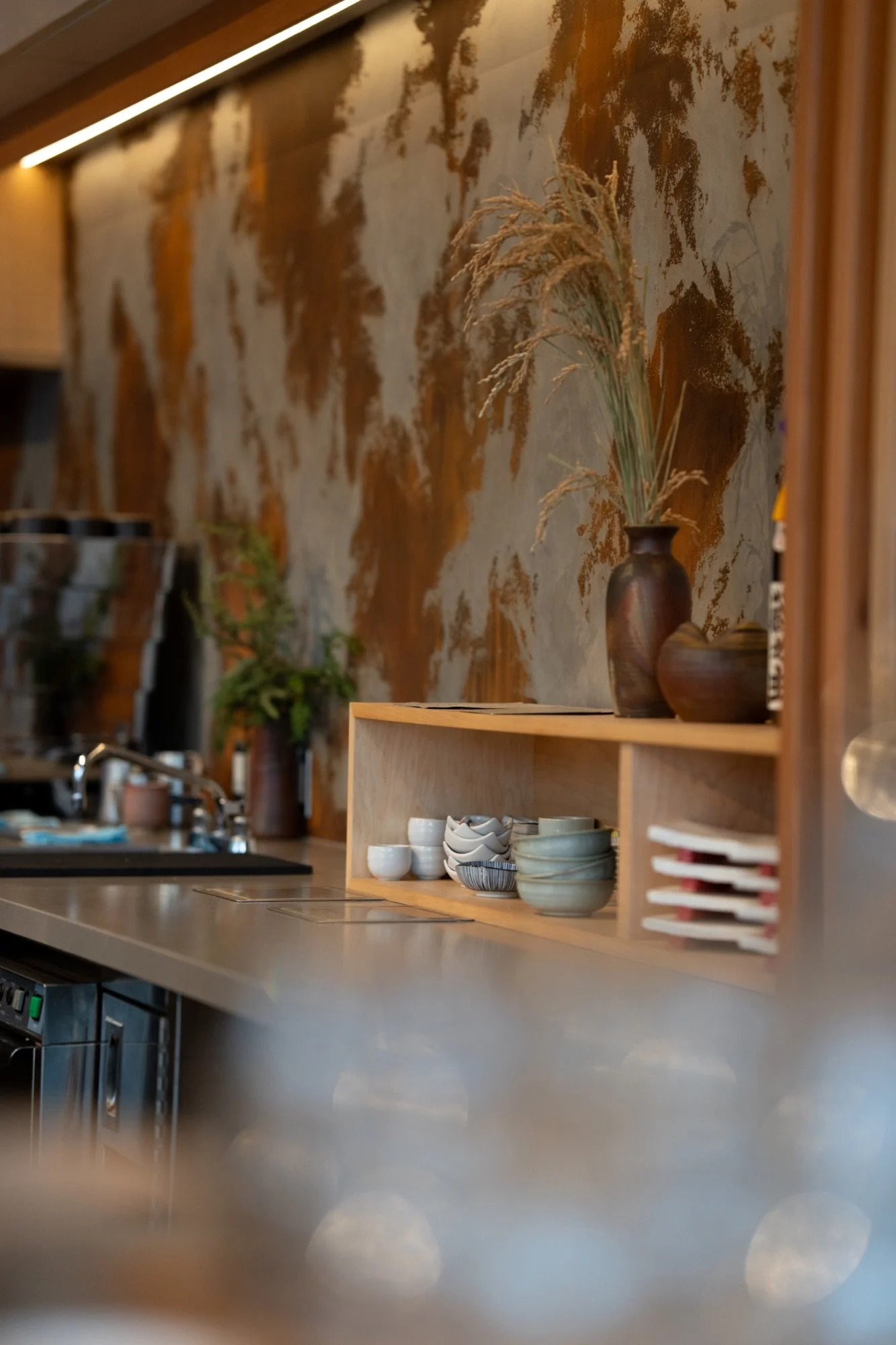 Warm counter details and ceramics at Hush Coffee