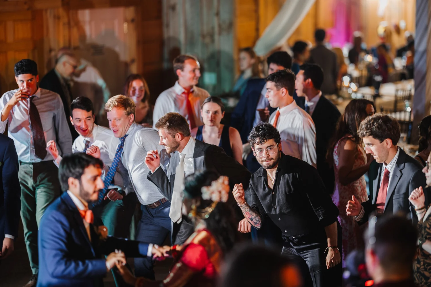 Guests crowding around dancers in the middle of the barn dance floor