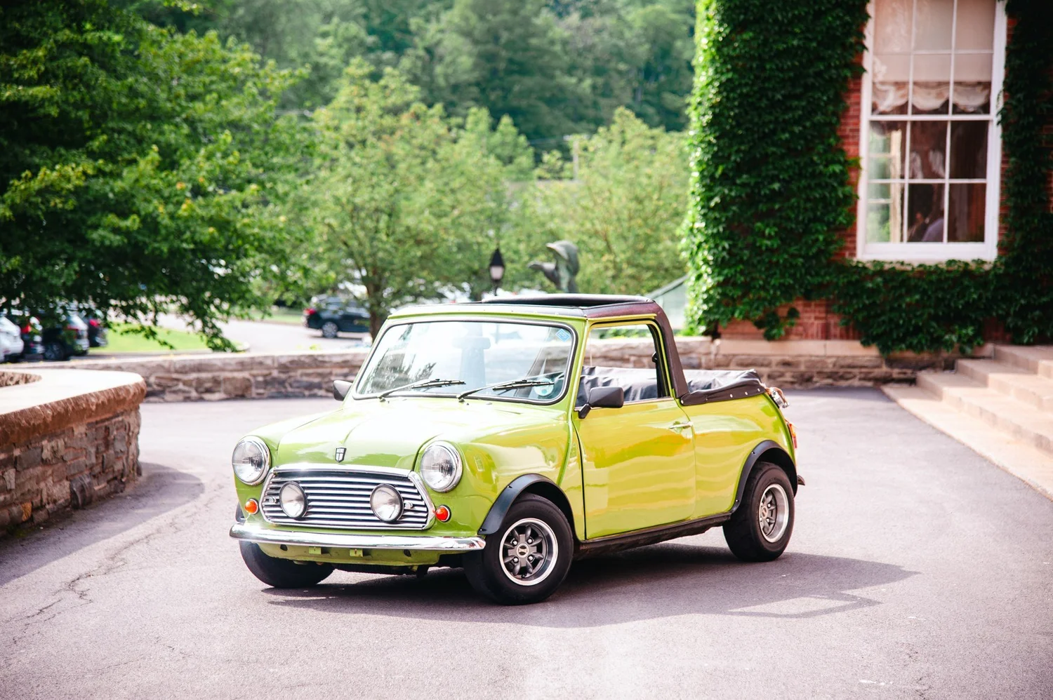 Green Mini Cooper by the white columns at The Otesaga
